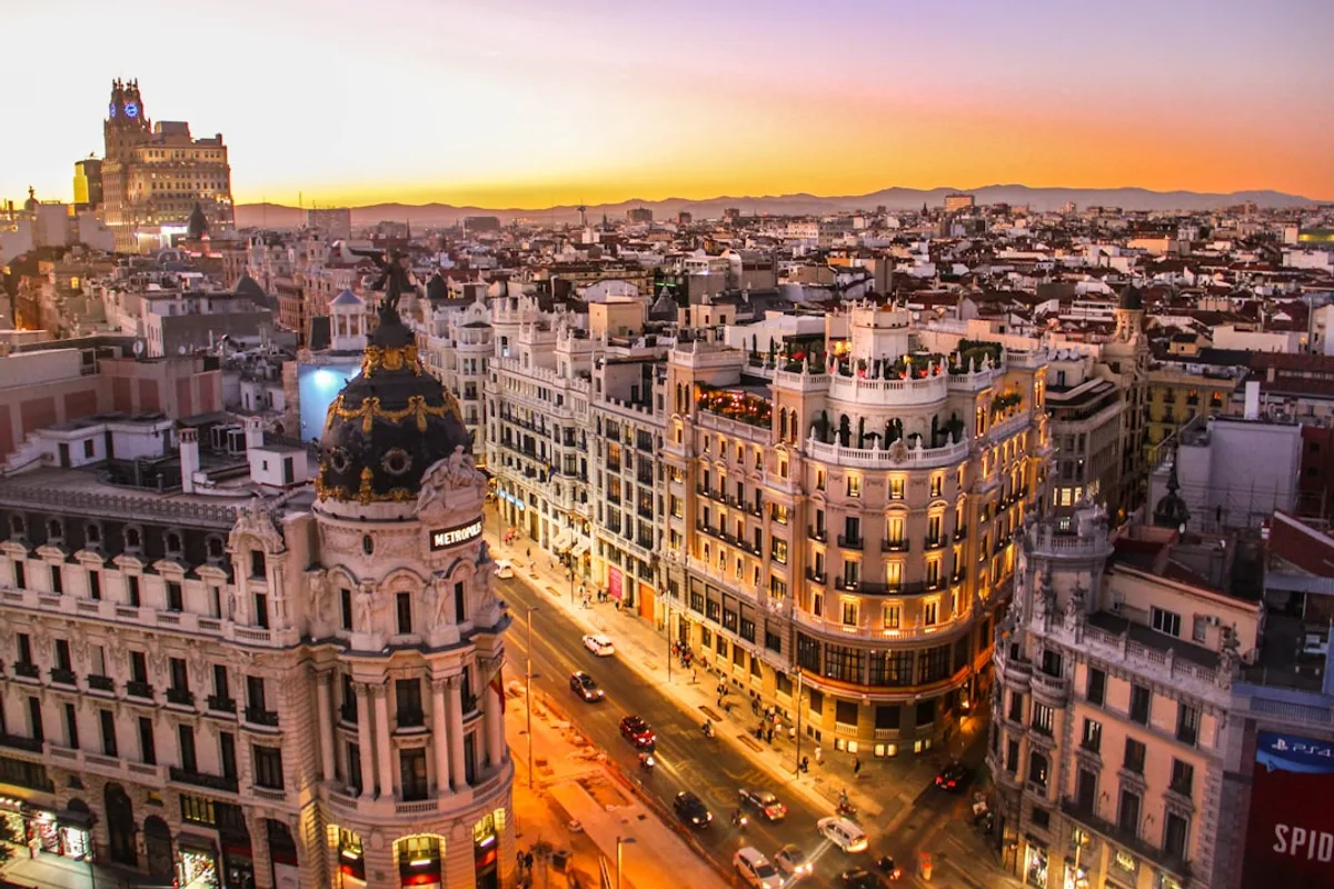 Gran Via street in Madrid lined with early 20th-century towers at dusk