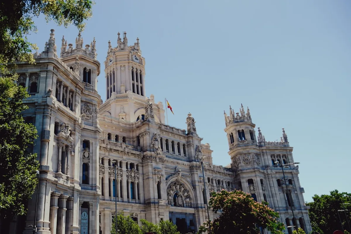 The Cibeles Fountain at night with the Palacio de Cibeles illuminated behind it