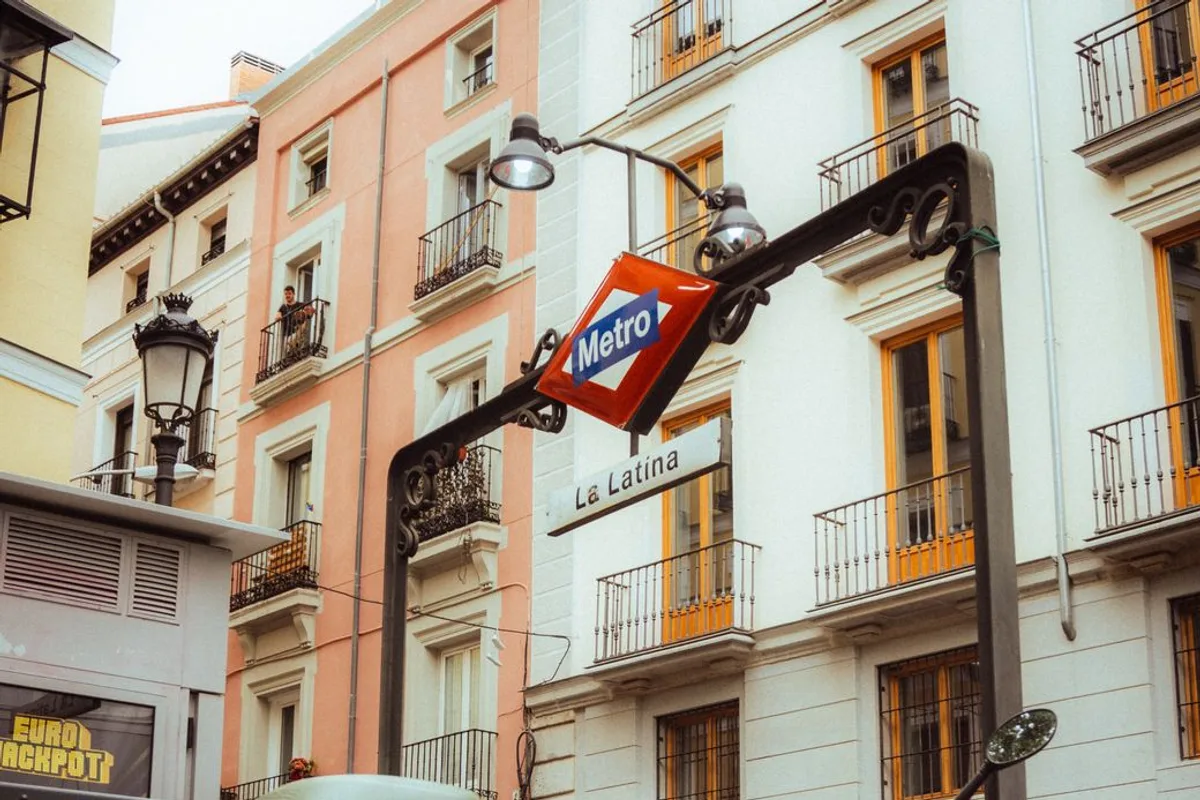 The Madrid Metro sign for La Latina station against colourful building facades