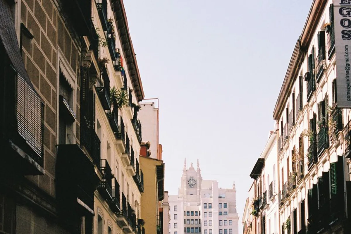 A narrow street of traditional balconied buildings in Malasaña, Madrid