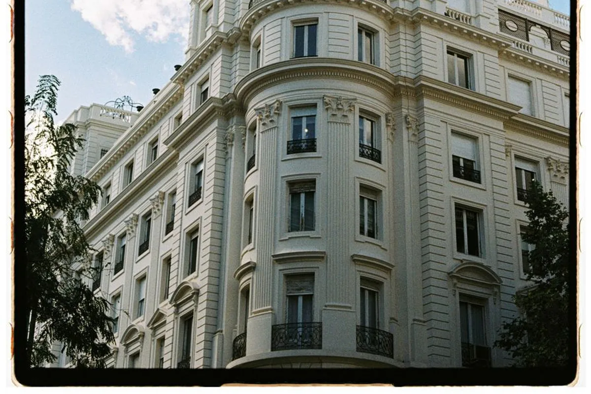 An elegant 19th-century apartment building facade with wrought-iron balconies in Salamanca, Madrid